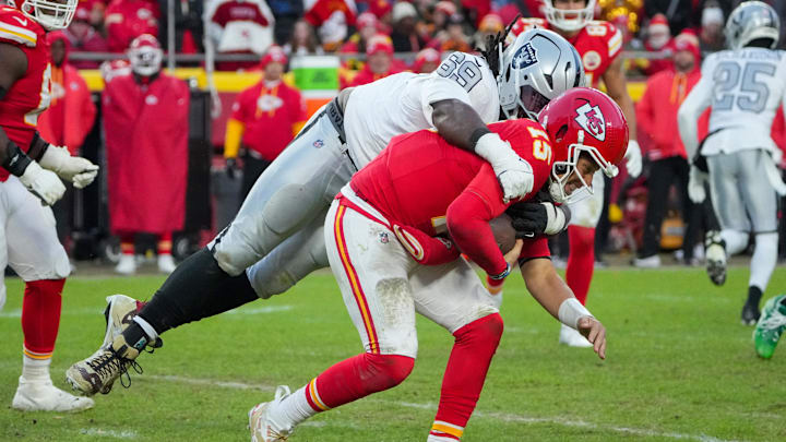 Nov 29, 2024; Kansas City, Missouri, USA; Kansas City Chiefs quarterback Patrick Mahomes (15) is sacked by Las Vegas Raiders defensive tackle Adam Butler (69) during the second half at GEHA Field at Arrowhead Stadium. Mandatory Credit: Denny Medley-Imagn Images