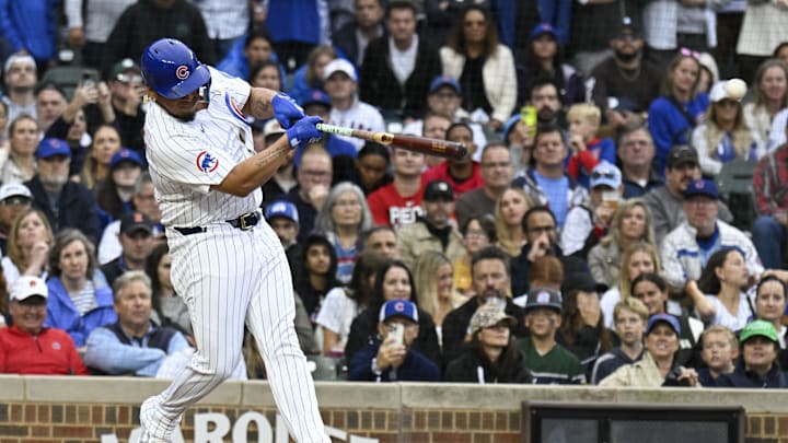 Sep 28, 2024; Chicago, Illinois, USA;  Chicago Cubs third baseman Isaac Paredes (17) hits an RBI single during the eighth inning against the Cincinnati Reds at Wrigley Field. Mandatory Credit: Matt Marton-Imagn Images