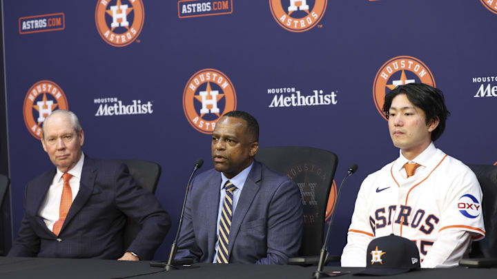 Jan 5, 2026; Houston, TX, USA; Houston Astros general manager Dana Brown (middle) talks and owner Jim Crane (left) looks on during a press conference to introduce Japanese pitcher Tatsuya Imai at Daikin Park. Mandatory Credit: Troy Taormina-Imagn Images Jan 5, 2026; Houston, TX, USA; Houston Astros general manager Dana Brown (middle) talks and owner Jim Crane (left) looks on during a press conference to introduce Japanese pitcher Tatsuya Imai at Daikin Park. Mandatory Credit: Troy Taormina-Imagn Images