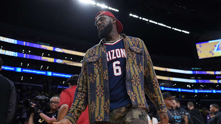 Oct 24, 2025; Los Angeles, California, USA; Los Angeles Lakers forward LeBron James poses in the Arizona Wildcats jersey of his son Bryce James (6) during the game against the Minnesota Timberwolves at Crypto.com Arena. Mandatory Credit: Kirby Lee-Imagn Images