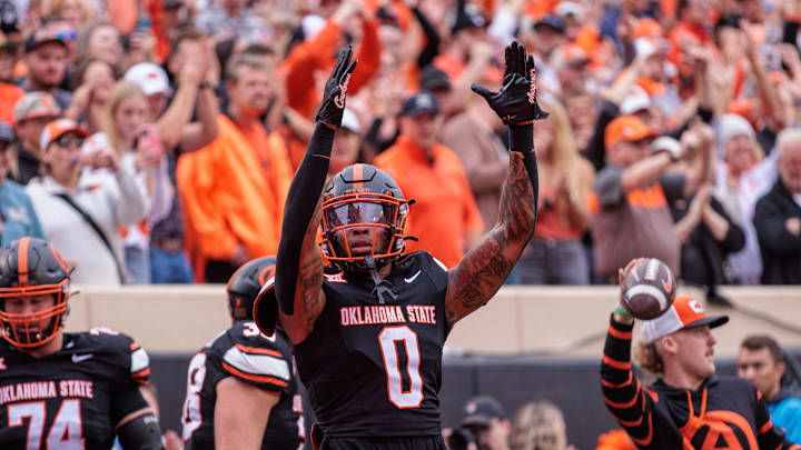 Nov 2, 2024; Stillwater, Oklahoma, USA; Oklahoma State Cowboys running back Ollie Gordon II (0) reacts after a touchdown during the second quarter against the Arizona State Sun Devils at Boone Pickens Stadium. Mandatory Credit: William Purnell-Imagn Images Nov 2, 2024; Stillwater, Oklahoma, USA; Oklahoma State Cowboys running back Ollie Gordon II (0) reacts after a touchdown during the second quarter against the Arizona State Sun Devils at Boone Pickens Stadium. Mandatory Credit: William Purnell-Imagn Images