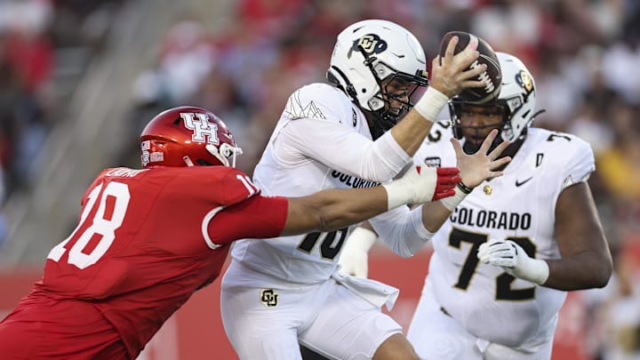 Sep 12, 2025; Houston, Texas, USA; Houston Cougars defensive lineman Khalil Laufau (18) tackles Colorado Buffaloes quarterback Ryan Staub (16) during the first quarter at TDECU Stadium. Mandatory Credit: Troy Taormina-Imagn Images
