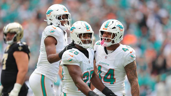 Nov 30, 2025; Miami Gardens, Florida, USA; Miami Dolphins linebacker Tyrel Dodson (25) celebrates with teammates linebacker K.J. Britt (3) and linebacker Chop Robinson (44) after breaking up a pass against the New Orleans Saints during the first half at Hard Rock Stadium. Mandatory Credit: Sam Navarro-Imagn Images