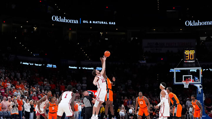 Oklahoma Sooners forward Sam Godwin (10) and Oklahoma State Cowboys forward Robert Jennings II (25) jump for the ball during the opening tip during a men's college Bedlam basketball game between the University of Oklahoma Sooners (OU) and the Oklahoma State University Cowboys (OSU) at Paycom Center in Oklahoma City, Saturday, Dec. 14, 2024. Oklahoma won 80-65.