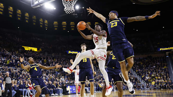 Jan 10, 2026; Ann Arbor, Michigan, USA;  Wisconsin Badgers guard John Blackwell (25) shoots on Michigan Wolverines forward Yaxel Lendeborg (23) in the second half at Crisler Center. 