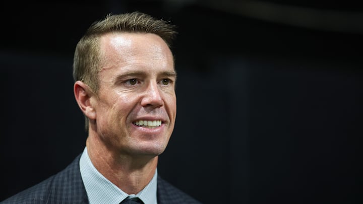 Oct 3, 2024; Atlanta, Georgia, USA; Former Atlanta Falcons quarterback Matt Ryan (2) on the sideline before being inducted in the team’s ring of honor at halftime of a game against the Tampa Bay Buccaneers at Mercedes-Benz Stadium. Mandatory Credit: Brett Davis-Imagn Images
