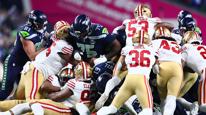 Jan 17, 2026; Seattle, WA, USA; Seattle Seahawks quarterback Sam Darnold (14) gets a first down on a “tush push” against the San Francisco 49ers during the first half in an NFC Divisional Round game at Lumen Field. Mandatory Credit: Kevin Ng-Imagn Images