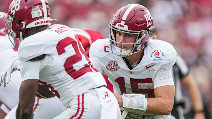 Alabama Crimson Tide quarterback Ty Simpson (15) hands off the ball to Alabama Crimson Tide running back Kevin Riley (28) on Thursday, Jan. 1, 2026, during the 112th annual Rose Bowl game in Pasadena. Indiana Hoosiers defeated Alabama Crimson Tide, 38-3.