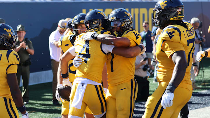 West Virginia University receiver Cam Vaughn (4) celebrates his first touchdown of the season with teammate Jahiem White (1)