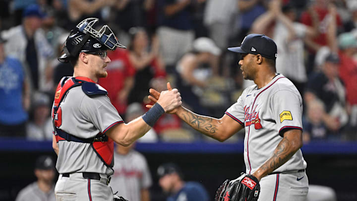 Jul 28, 2025; Kansas City, Missouri, USA;  Atlanta Braves relief pitcher Raisel Iglesias (26) shakes hands with catcher Sean Murphy (12) after beating the Kansas City Royals at Kauffman Stadium. Mandatory Credit: Peter Aiken-Imagn Images