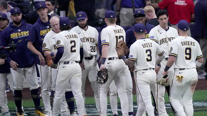 Milwaukee Brewers designated hitter Christian Yelich (22) congratulates his teammates after their NLCS GAME Sunday, Oct. 11, 2026 at American Family Field in Milwaukee, Wisconsin. Yelich did not play. The Milwaukee Brewers beat the Los Angeles Dodgers 2-1.