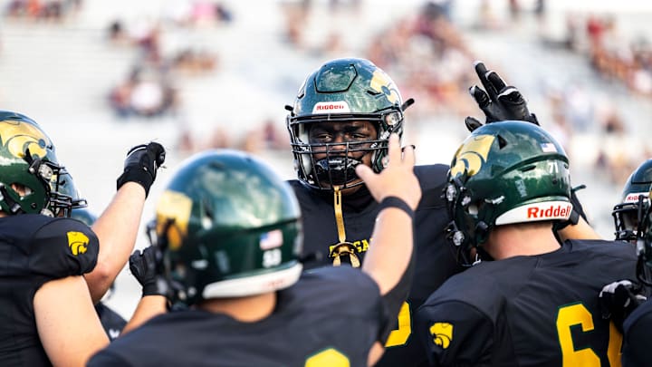 Cedar Rapids Kennedy's Nick Brooks huddles up with teammates during a Class 5A high school football game against Dowling Catholic, Saturday, Aug. 26, 2023, at Kingston Stadium in Cedar Rapids, Iowa.