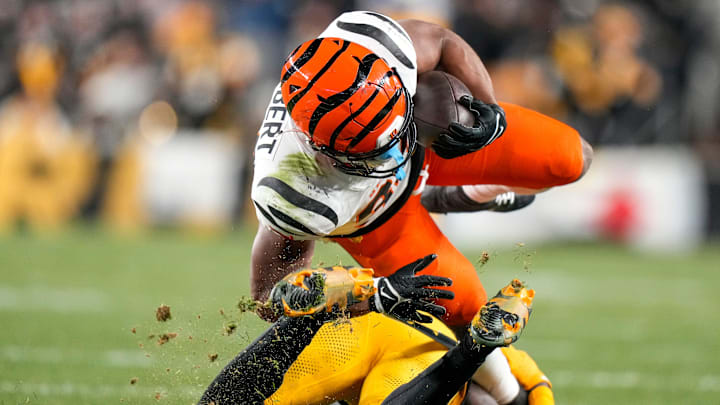 Cincinnati Bengals running back Khalil Herbert (34) is brought down by Pittsburgh Steelers cornerback Joey Porter Jr. (24) on a carry in the second quarter of the NFL Week 18 game between the Pittsburgh Steelers and the Cincinnati Bengals at Acrisure Stadium in Pittsburgh on Saturday, Jan. 4, 2025.