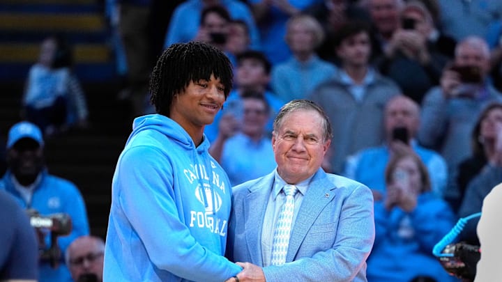 Dec 14, 2024; Chapel Hill, North Carolina, USA; North Carolina Tar Heels head football coach Bill Belichick with recruit quarterback Bryce Baker during half time at Dean E. Smith Center. Dec 14, 2024; Chapel Hill, North Carolina, USA; North Carolina Tar Heels head football coach Bill Belichick with recruit quarterback Bryce Baker during half time at Dean E. Smith Center.