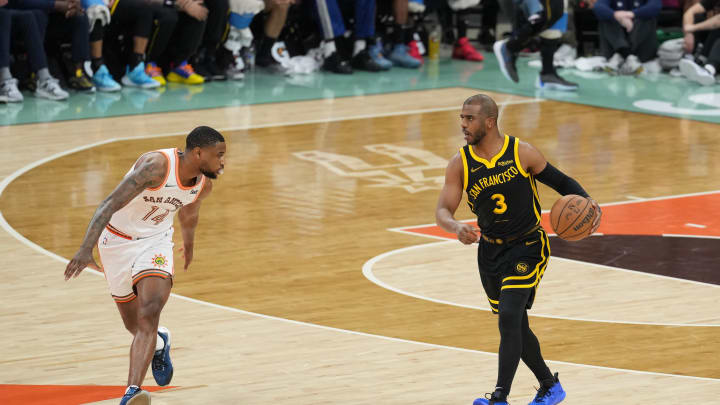 Mar 31, 2024; San Antonio, Texas, USA;  Golden State Warriors guard Chris Paul (3) dribbles in front of San Antonio Spurs guard Blake Wesley (14) in the first half at Frost Bank Center. Mandatory Credit: Daniel Dunn-USA TODAY Sports