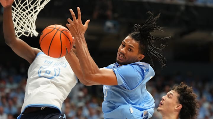 Oct 4, 2025; Charlotte, NC, USA; North Carolina Tar Heels forward Jarin Stevenson (15) and forward Caleb Wilson (8) fight for a rebound in the first half at Dean E. Smith Center. 