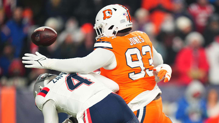 Dec 24, 2023; Denver, Colorado, USA; Denver Broncos defensive tackle D.J. Jones (93) sacks New England Patriots quarterback Bailey Zappe (4) in the first quarter at Empower Field at Mile High. Mandatory Credit: Ron Chenoy-Imagn Images