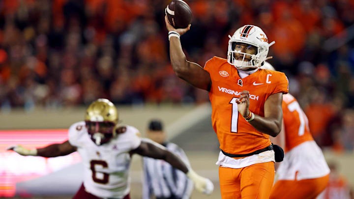 Oct 17, 2024; Blacksburg, Virginia, USA; Virginia Tech Hokies quarterback Kyron Drones (1) throws a touchdown during the second quarter against the Boston College Eagles at Lane Stadium. Mandatory Credit: Peter Casey-Imagn Images