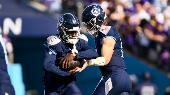 Nov 17, 2024; Nashville, Tennessee, USA; Tennessee Titans Will Levis (8) hands the ball to running back Tyjae Spears (2) warms up before a game against the Minnesota Vikings at Nissan Stadium. Mandatory Credit: Steve Roberts-Imagn Images