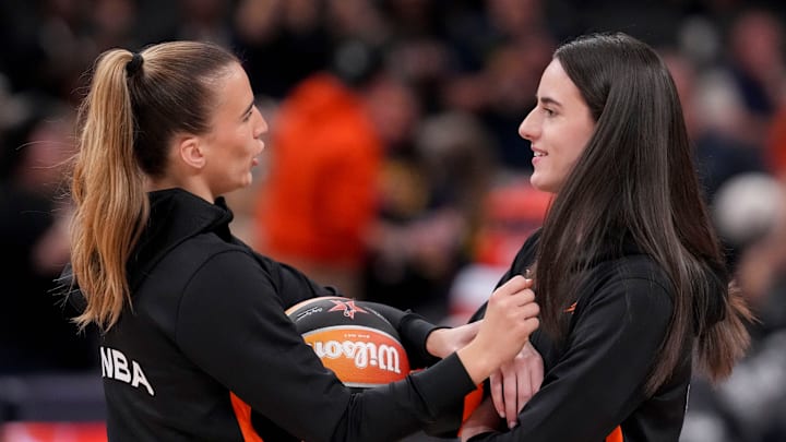 New York Liberty's Sabrina Ionescu (20) and Indiana Fever's Caitlin Clark (22) talk during warmups Saturday, July 19, 2025, ahead of the WNBA All-Star Game at Gainbridge Fieldhouse in Indianapolis.