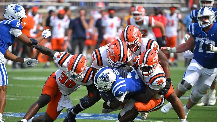 Sep 6, 2025; Durham, North Carolina, USA;  Duke Blue Devils cornerback Kimari Robinson (5) is tackled by Illinois Fighting Illini linebacker Jojo Hayden (30), linebacker Kenenna Odeluga (39), linebacker Ismael Kante (26) and defensive lineman Gentle Hunt (92) during the fourth quarter at Wallace Wade Stadium. Mandatory Credit: Zachary Taft-Imagn Images