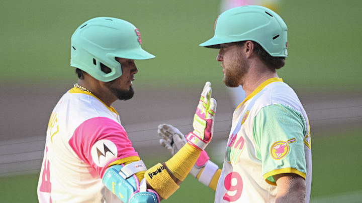 Aug 23, 2024; San Diego, California, USA; San Diego Padres first baseman Luis Arraez (4), left, is congratulated by Jake Cronenworth (9) after hitting a solo home run during the first inning against the New York Mets at Petco Park. Mandatory Credit: Denis Poroy-Imagn Images