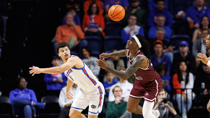 Nov 22, 2024; Gainesville, Florida, USA; Florida Gators guard Walter Clayton Jr. (1) and Southern Illinois Salukis guard Kennard Davis Jr. (30) battle for a loose ball during the second half at Exactech Arena at the Stephen C. O'Connell Center. Mandatory Credit: Matt Pendleton-Imagn Images