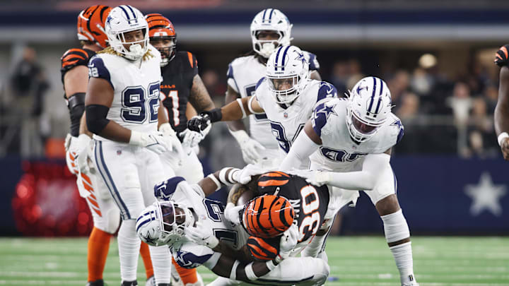Dec 9, 2024; Arlington, Texas, USA; Cincinnati Bengals running back Chase Brown (30) is tackled by Dallas Cowboys linebacker DeMarvion Overshown (13) in the second quarter  at AT&T Stadium. Mandatory Credit: Tim Heitman-Imagn Images