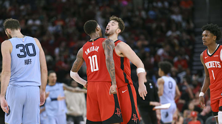 Oct 25, 2024; Houston, Texas, USA; Houston Rockets center Alperen Sengun (28) celebrates with forward Jabari Smith Jr. (10) after a play during the third quarter against the Memphis Grizzlies at Toyota Center. Mandatory Credit: Troy Taormina-Imagn Images
