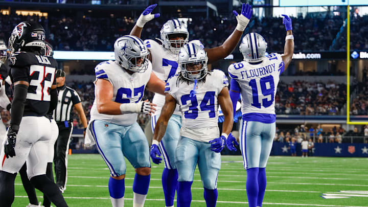 Teammates celebrate with Dallas Cowboys running back Jaydon Blue after he scores a touchdown against the Atlanta Falcons 