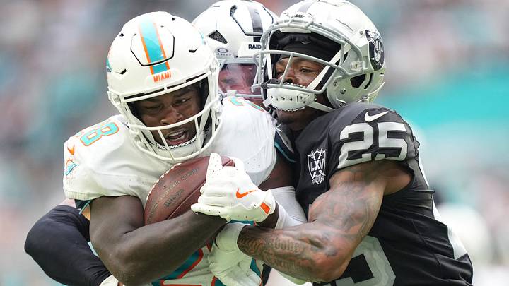 Miami Dolphins running back De'Von Achane breaks free for a big gain in the third quarter as Las Vegas Raiders cornerback Decamerion Richardson (25) and safety Tre'von Moehrig (7) drive him out of bounds at Hard Rock Stadium in a 2024 game.