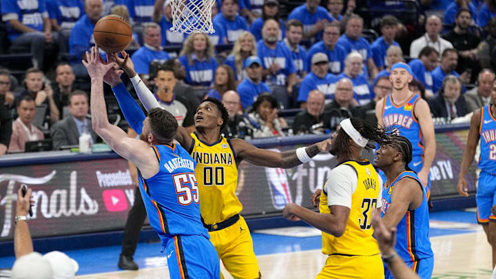 Jun 8, 2025; Oklahoma City, Oklahoma, USA; Oklahoma City Thunder center Isaiah Hartenstein (55) and Indiana Pacers guard Bennedict Mathurin (00) battle for the loose ball during the second quarter of game two of the 2025 NBA Finals at Paycom Center. Mandatory Credit: Kyle Terada-Imagn Images