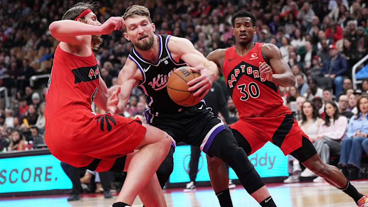 Mar 20, 2024; Toronto, Ontario, CAN; Sacramento Kings forward Domantas Sabonis (10) controls the ball as Toronto Raptors forward Kelly Olynyk (41) tries to defend during the second quarter at Scotiabank Arena. Mandatory Credit: Nick Turchiaro-Imagn Images Mar 20, 2024; Toronto, Ontario, CAN; Sacramento Kings forward Domantas Sabonis (10) controls the ball as Toronto Raptors forward Kelly Olynyk (41) tries to defend during the second quarter at Scotiabank Arena. Mandatory Credit: Nick Turchiaro-Imagn Images
