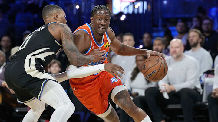 Dec 17, 2024; Las Vegas, Nevada, USA; Oklahoma City Thunder forward Jalen Williams (8) drives against Milwaukee Bucks guard Damian Lillard (0) during the 1st quarter of the Emirates NBA Cup championship game at T-Mobile Arena. Mandatory Credit: Kyle Terada-Imagn Images