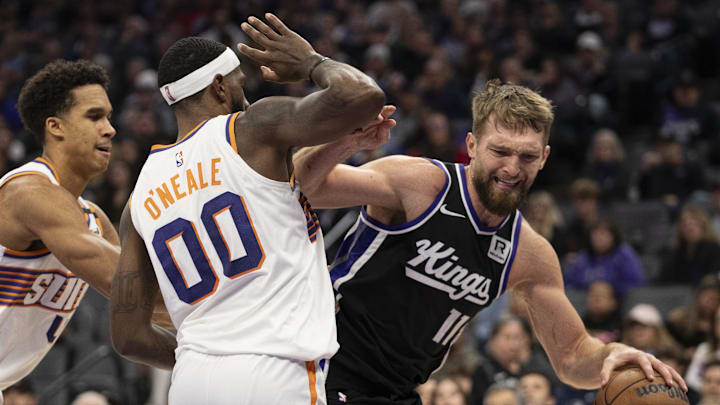 November 13, 2024; Sacramento, California, USA; Sacramento Kings forward Domantas Sabonis (11) is defended by Phoenix Suns forward Royce O'Neale (00) during the second quarter at Golden 1 Center. Mandatory Credit: Kyle Terada-Imagn Images November 13, 2024; Sacramento, California, USA; Sacramento Kings forward Domantas Sabonis (11) is defended by Phoenix Suns forward Royce O'Neale (00) during the second quarter at Golden 1 Center. Mandatory Credit: Kyle Terada-Imagn Images