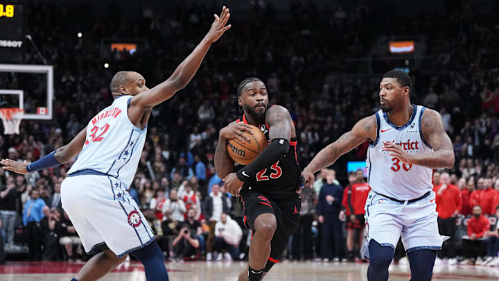 Mar 8, 2025; Toronto, Ontario, CAN; Toronto Raptors guard Jamal Shead (23) controls the ball as Washington Wizards forward Khris Middleton (32) and guard Marcus Smart (36) try to defend during the fourth quarter at Scotiabank Arena. Mandatory Credit: Nick Turchiaro-Imagn Images