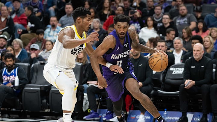 December 16, 2023; Sacramento, California, USA; Sacramento Kings guard Malik Monk (0) is guarded by Utah Jazz guard Ochai Agbaji (30).
