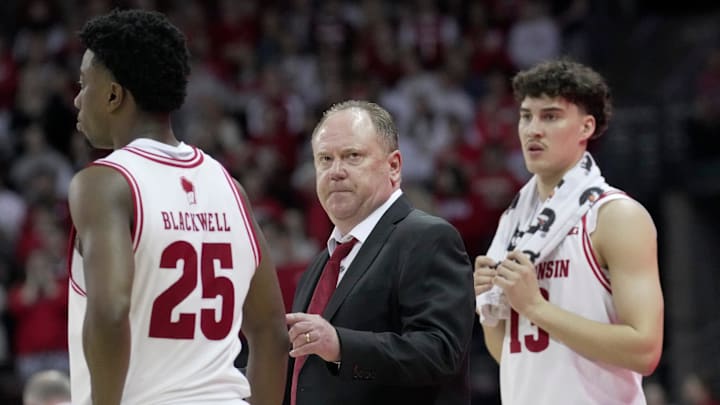 Wisconsin head coach Greg Gard is shown between guard John Blackwell (25) and guard Hayden Jones (13) during the second half of their game Wednesday, March 4, 2026 at the Kohl Center in Madison, Wisconsin. Wisconsin beat Maryland 78-45. Wisconsin head coach Greg Gard is shown between guard John Blackwell (25) and guard Hayden Jones (13) during the second half of their game Wednesday, March 4, 2026 at the Kohl Center in Madison, Wisconsin. Wisconsin beat Maryland 78-45.