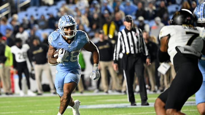North Carolina Tar Heels running back Omarion Hampton runs as Wake Forest Demon Deacons defensive back Evan Slocum