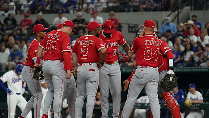 Apr 16, 2025; Arlington, Texas, USA; Los Angeles Angels starting pitcher Jose Soriano (59) is visited on the mound by pitching coach Barry Enright (84) and teammates during the second inning against the Texas Rangers at Globe Life Field. Mandatory Credit: Raymond Carlin III-Imagn Images