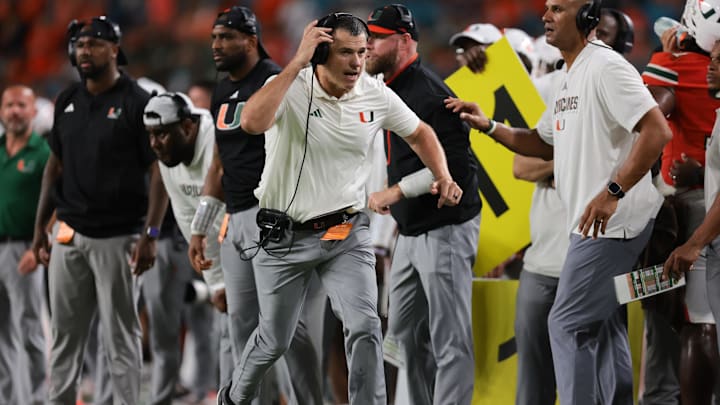 Sep 13, 2025; Miami Gardens, Florida, USA; Miami Hurricanes head coach Mario Cristobal runs on the sideline against the South Florida Bulls during the fourth quarter  at Hard Rock Stadium. Mandatory Credit: Sam Navarro-Imagn Images