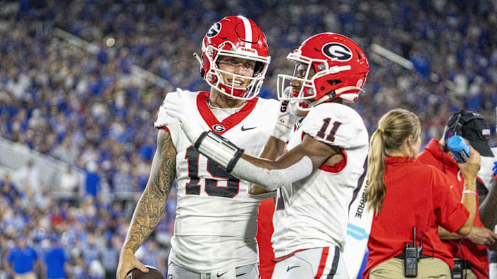 Sep 14, 2024; Lexington, Kentucky, USA; Georgia Bulldogs quarterback Carson Beck (15) and wide receiver Arian Smith (11) talk during a time out during the second quarter against the Kentucky Wildcats at Kroger Field. Mandatory Credit: Tanner Pearson-Imagn Images