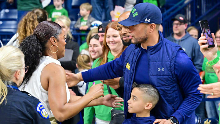 Mar 3, 2024; South Bend, Indiana, USA; Notre Dame Fighting Irish head coach Niele Ivey greets football coach Marcus Freeman after Notre Dame defeated the Louisville Cardinals at the Purcell Pavilion.