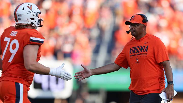 Aug 29, 2026; Charlottesville, Virginia, USA;  Virginia Cavaliers head coach Tony Elliott congratulates offensive lineman Jon Adair (79) during the game against the North Carolina State Wolfpack at Scott Stadium.  Mandatory Credit: Greg Atkins-Imagn Images