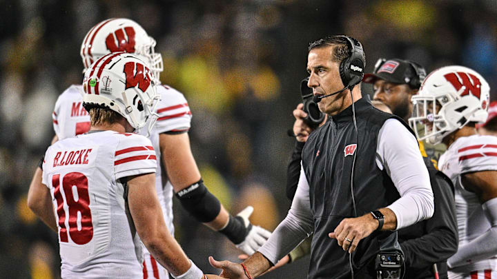 Nov 2, 2024; Iowa City, Iowa, USA; Wisconsin Badgers quarterback Braedyn Locke (18) reacts with head coach Luke Fickell during the fourth quarter against the Iowa Hawkeyes at Kinnick Stadium. Mandatory Credit: Jeffrey Becker-Imagn Images