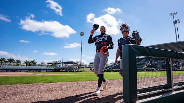 Pitcher Pablo Lopez, left, walks to the dugout after taking part in live batting practice during the Minnesota Twins first full-squad workout of spring training at Lee Health Sports Complex in Fort Myers, Fla., on Monday, Feb. 16, 2026.