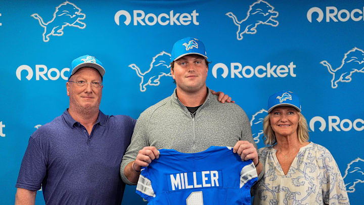 Detroit Lions first round draft Blake Miller, center, poses for a photo with his father Chris Miller, left, and mother Karen Miller at his introductory press conference at Meijer Performance Center in Allen Park on Friday, April 24, 2026.