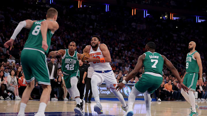 May 16, 2025; New York, New York, USA; New York Knicks center Karl-Anthony Towns (32) drives to the basket against Boston Celtics centers Kristaps Porzingis (8) and Al Horford (42) and guards Jaylen Brown (7) and Derrick White (9) during the first quarter of game six in the second round of the 2025 NBA Playoffs at Madison Square Garden. Mandatory Credit: Brad Penner-Imagn Images