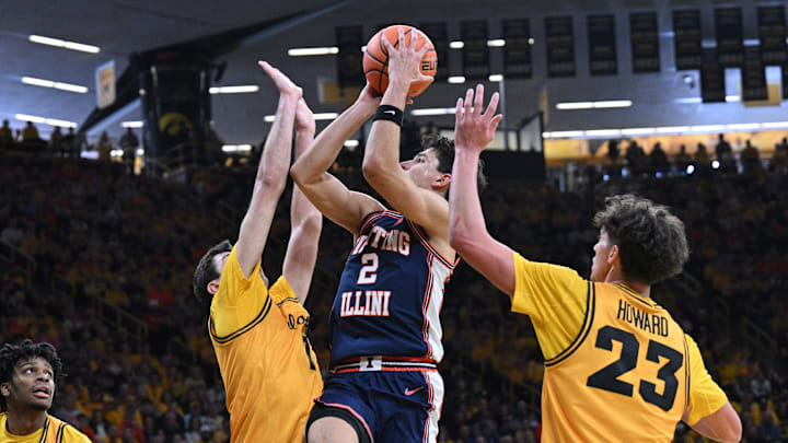 Jan 11, 2026; Iowa City, Iowa, USA; Illinois Fighting Illini guard Andrej Stojakovic (2) shoots the ball as Iowa Hawkeyes guard Isaia Howard (23) and forward Alvaro Folgueiras (7) and guard Isaia Howard (23) defend during the first half at Carver-Hawkeye Arena. Mandatory Credit: Jeffrey Becker-Imagn Images