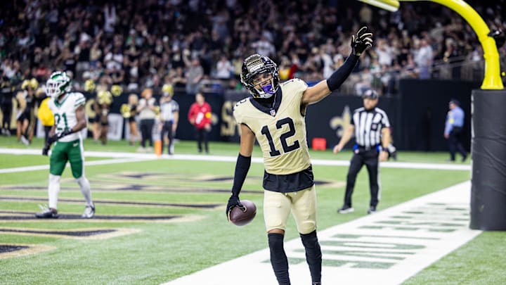 Dec 21, 2025; New Orleans, Louisiana, USA; New Orleans Saints wide receiver Chris Olave (12) waves to fans after scoring a touchdown against New York Jets cornerback Brandon Stephens (21) during the second half at Caesars Superdome. Mandatory Credit: Stephen Lew-Imagn Images Dec 21, 2025; New Orleans, Louisiana, USA; New Orleans Saints wide receiver Chris Olave (12) waves to fans after scoring a touchdown against New York Jets cornerback Brandon Stephens (21) during the second half at Caesars Superdome. Mandatory Credit: Stephen Lew-Imagn Images